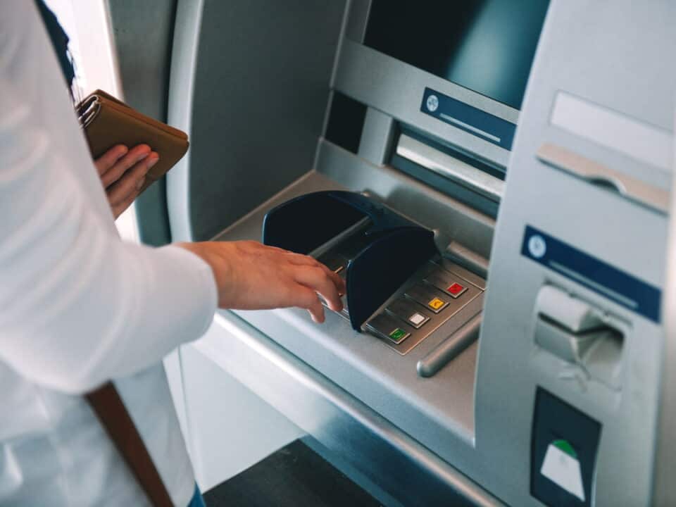 Woman pressing key pin code holding wallet