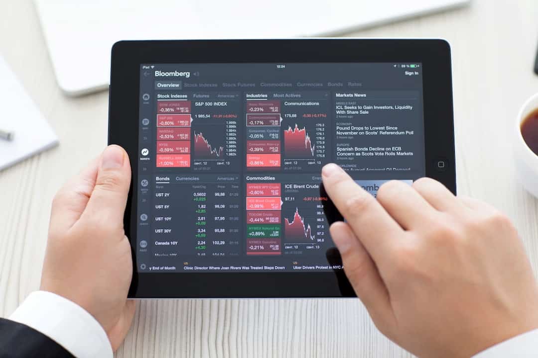 a person using Bloomberg app on tablet