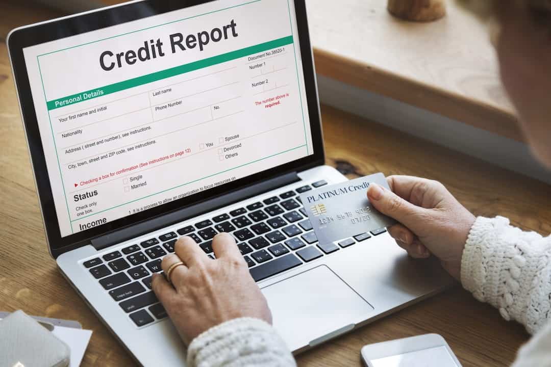 a person checking credit report on laptop