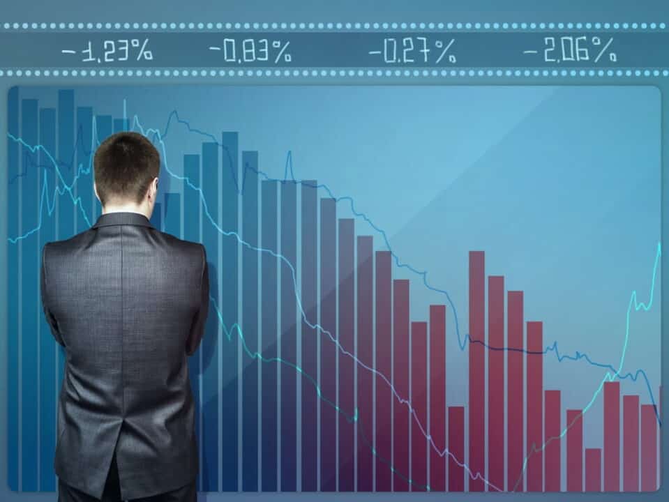 a man looking at the big stock graph