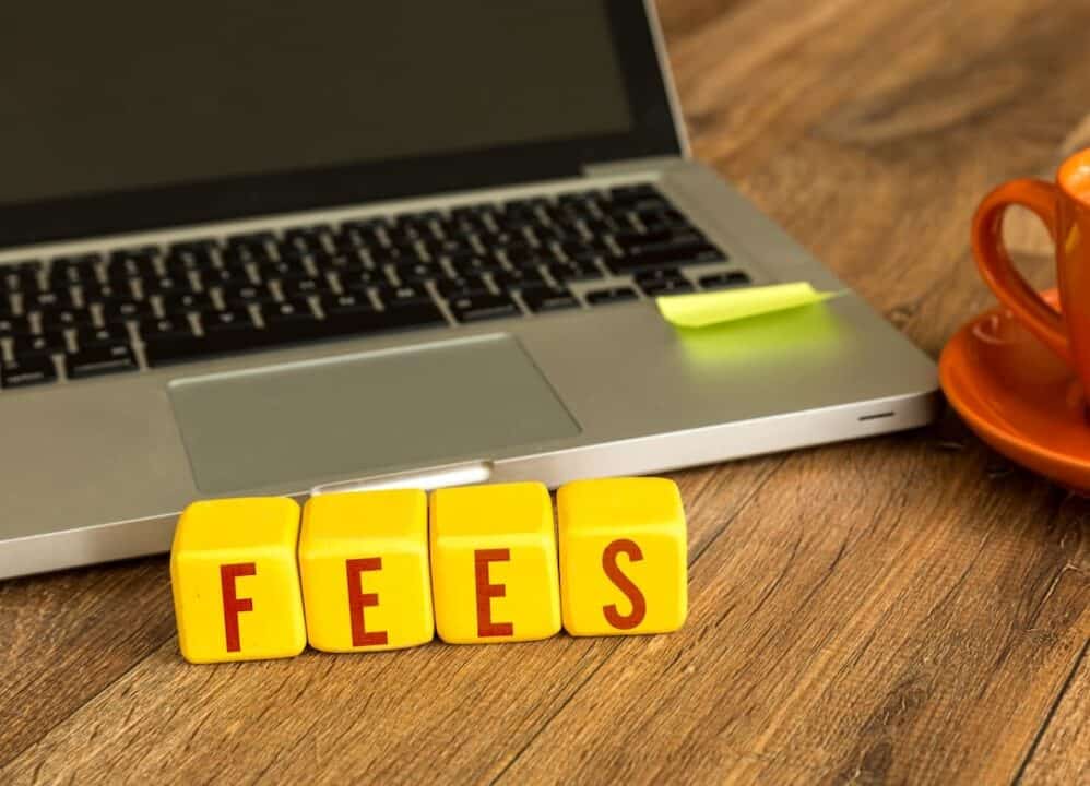 laptop and word FEES on the table