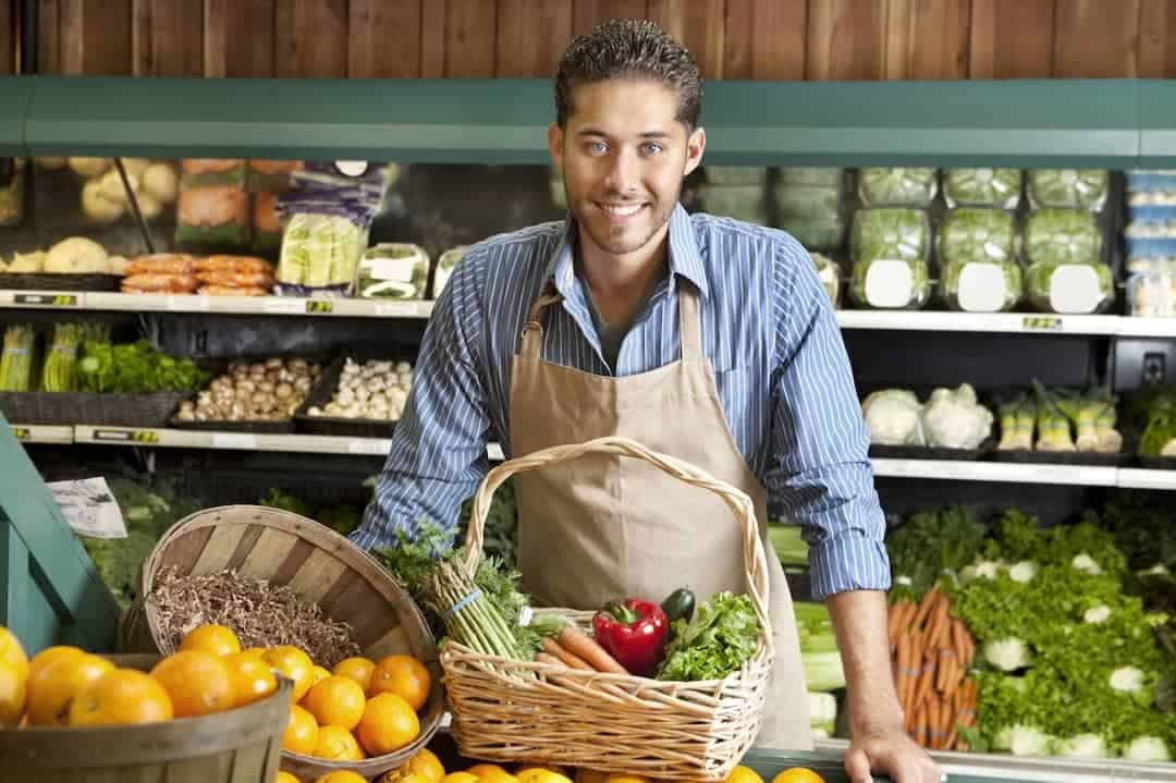 a smiling salesman in the groceries store