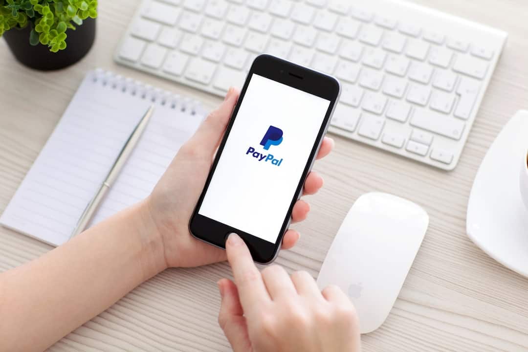 PayPal logo on the mobile display in person's hands
