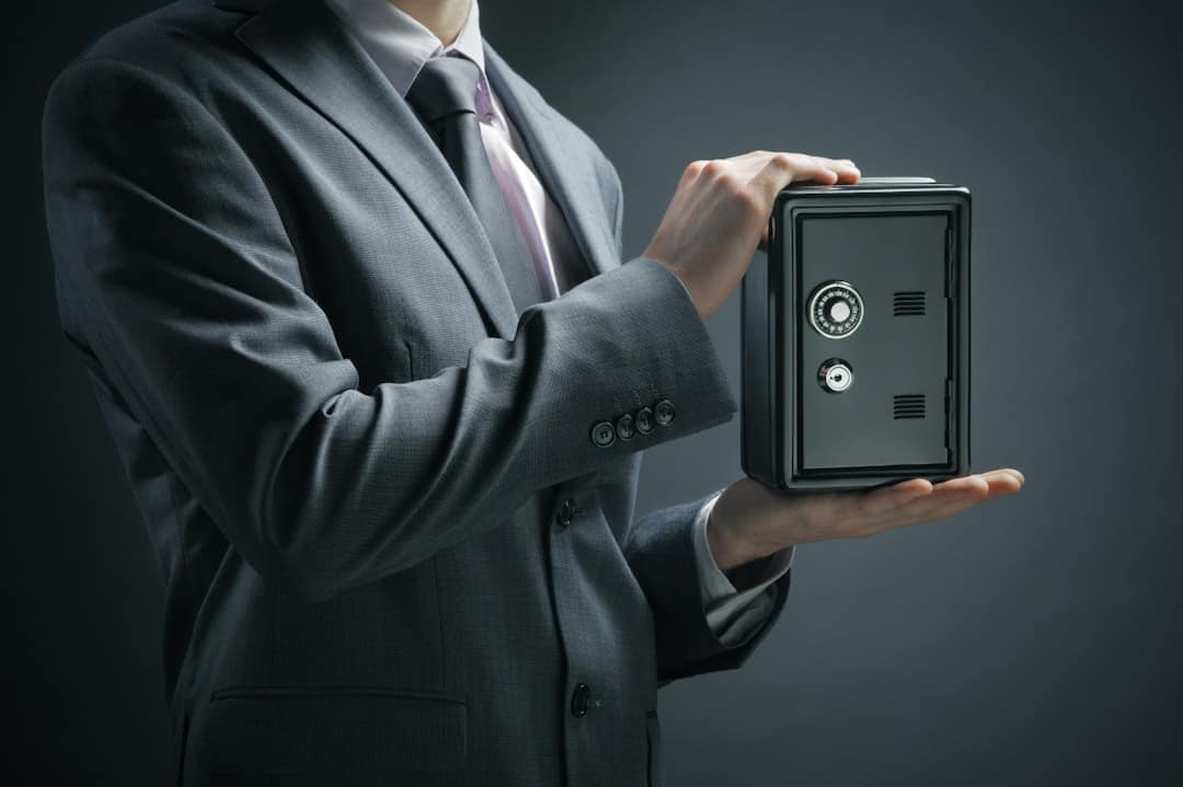 a man holding a safe