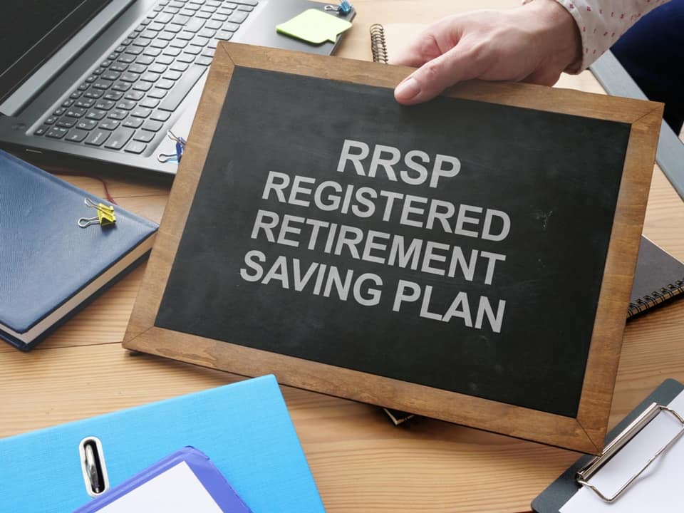 a hand holding a table with RRSP 