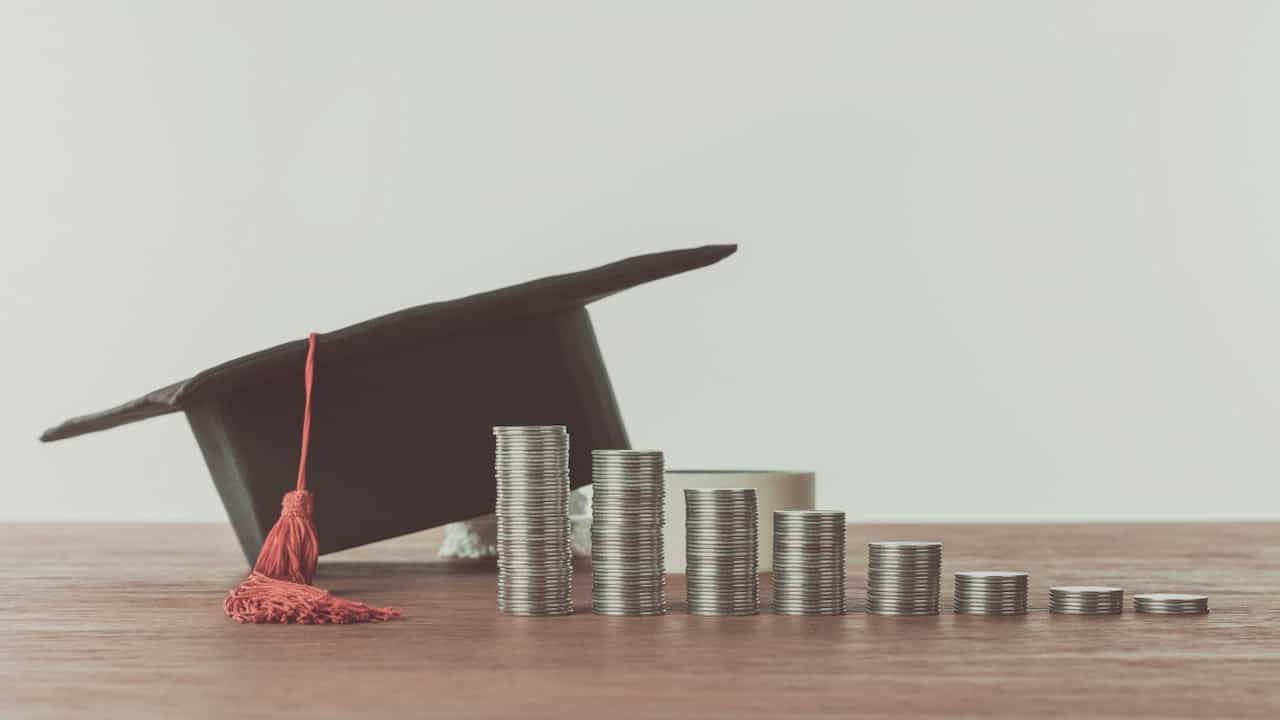 Coins and graduate cap on the table