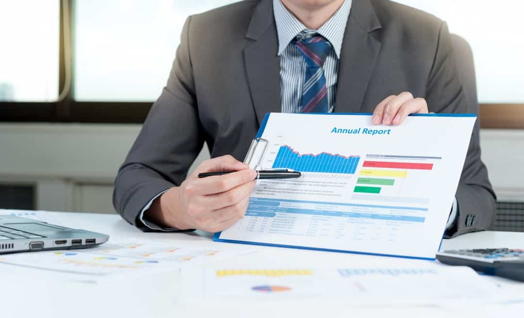 a man in a suit presenting annual report in his hands 