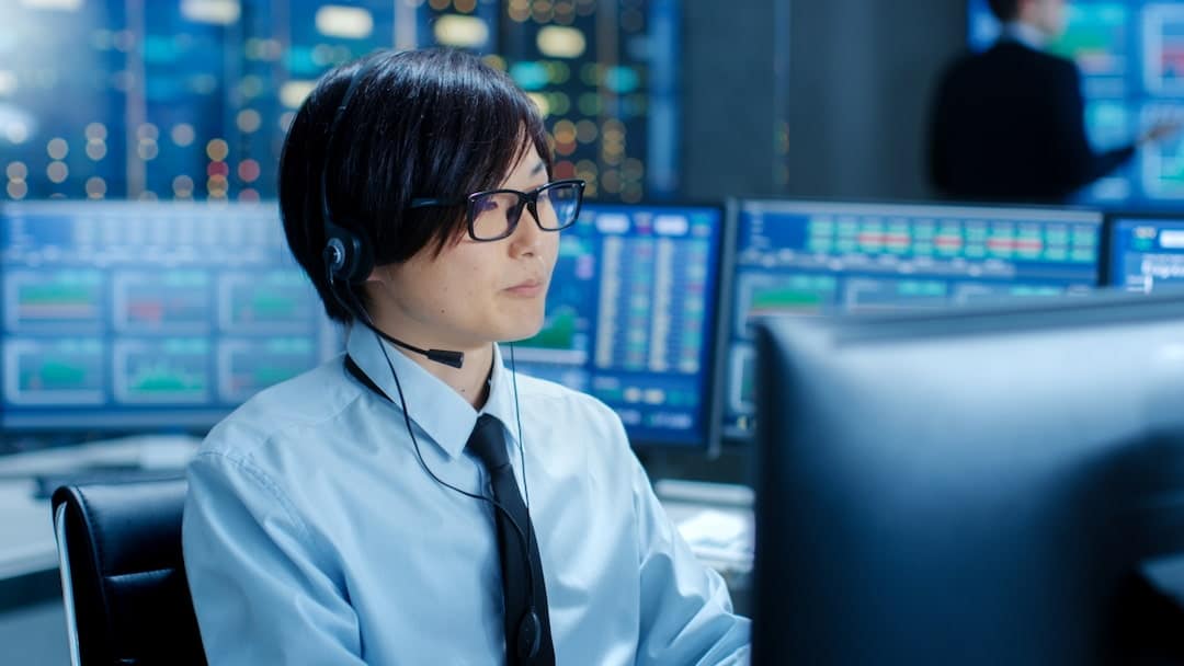 Stock trader looking at computer screens