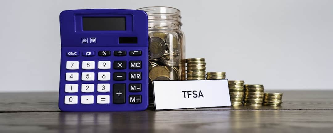 Calculator, TFSA tag and stack of coins