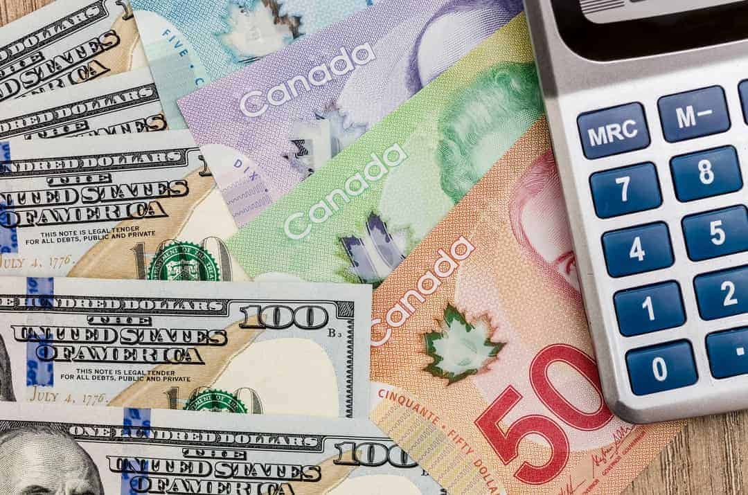 A calculator, American and Canadian dollars