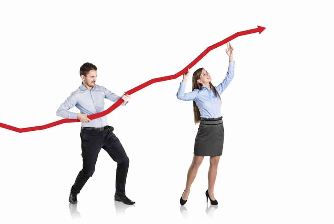 Woman and man holding statistics curve showing increasing