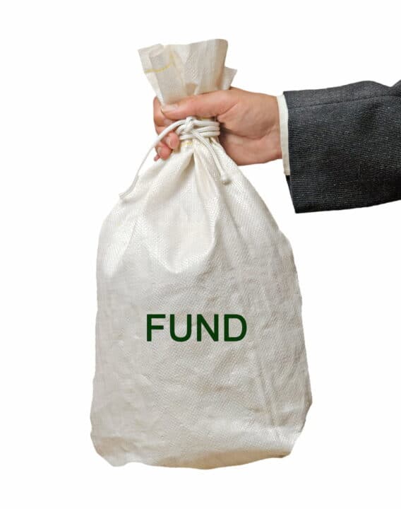 a hand holding the white fund bag