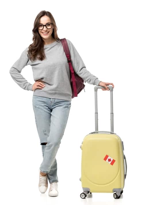 a young smiling woman with backpack and suitcase