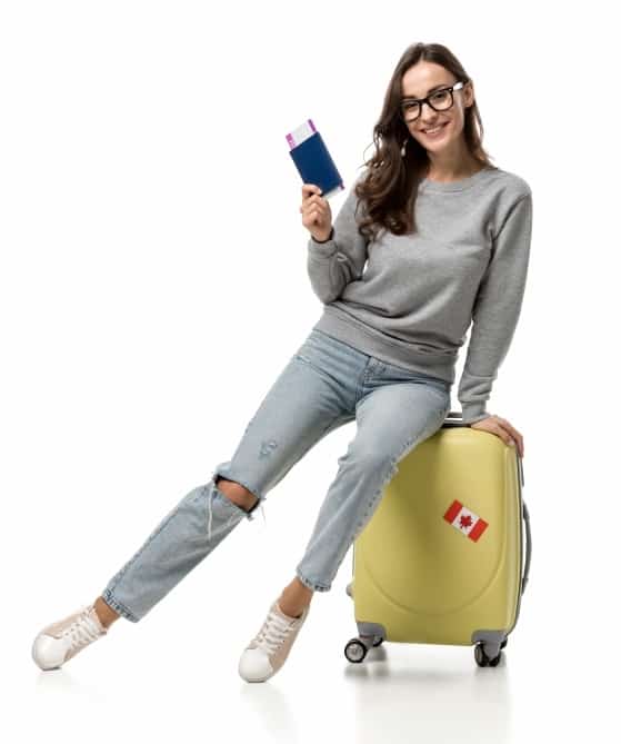 young woman with suitcase and an airplane ticket in her hand