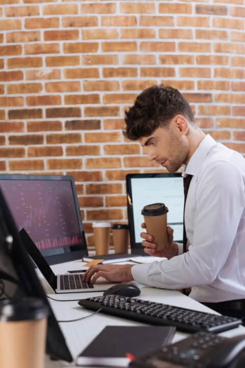 a man typing on laptop in the office