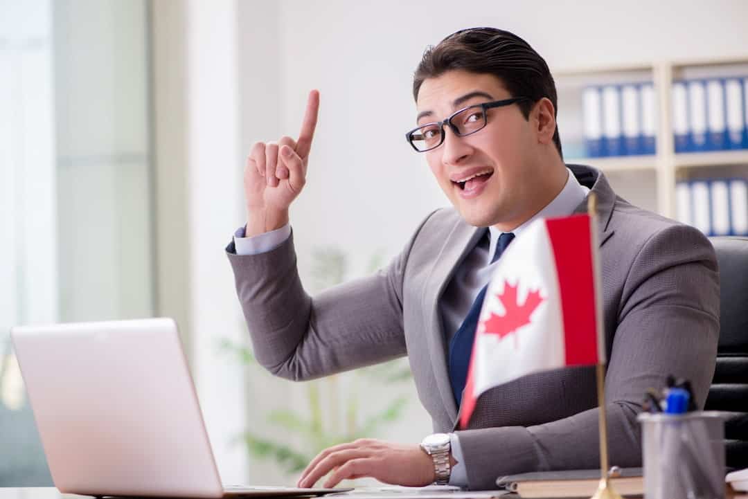 a man in the office with a Canadian flag on the table