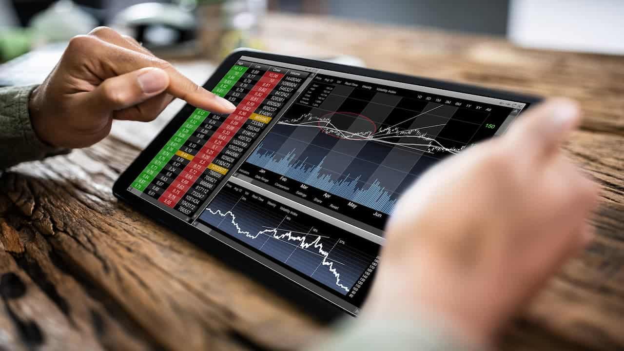 a person using tablet for stock trading