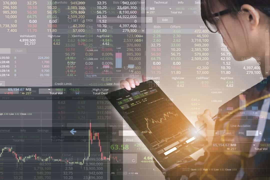 a woman with tablet and stock charts