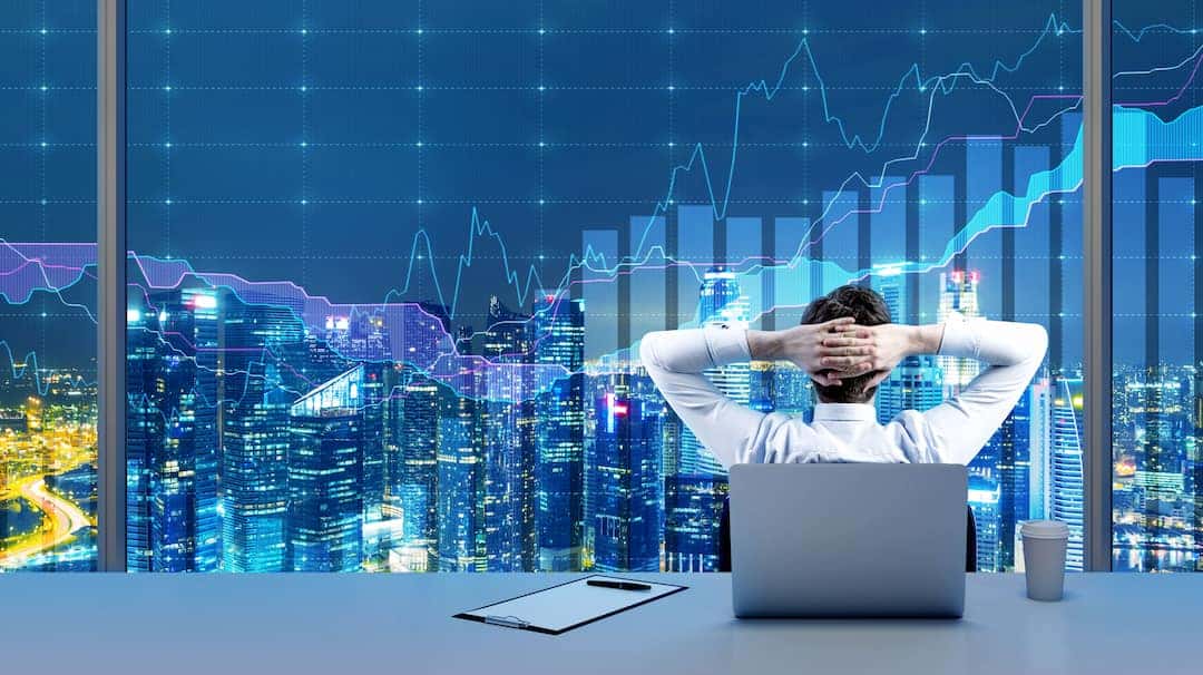 a trader looking at the stocks graphs on the big display