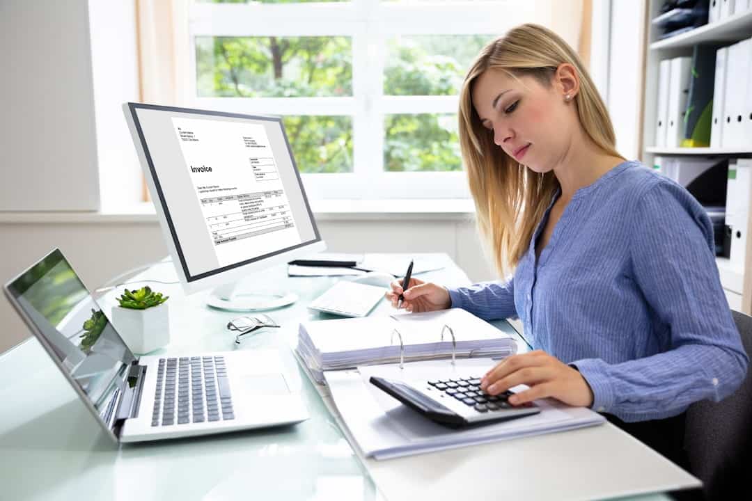 a woman calculating bills and taking notes