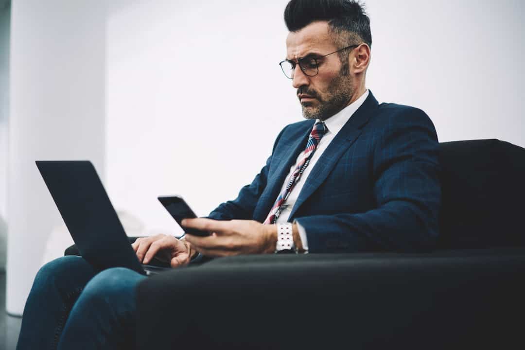 a man with laptop and cellphone