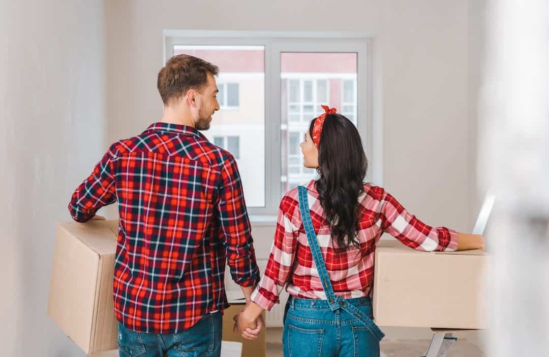 a couple holding hands in an empty room