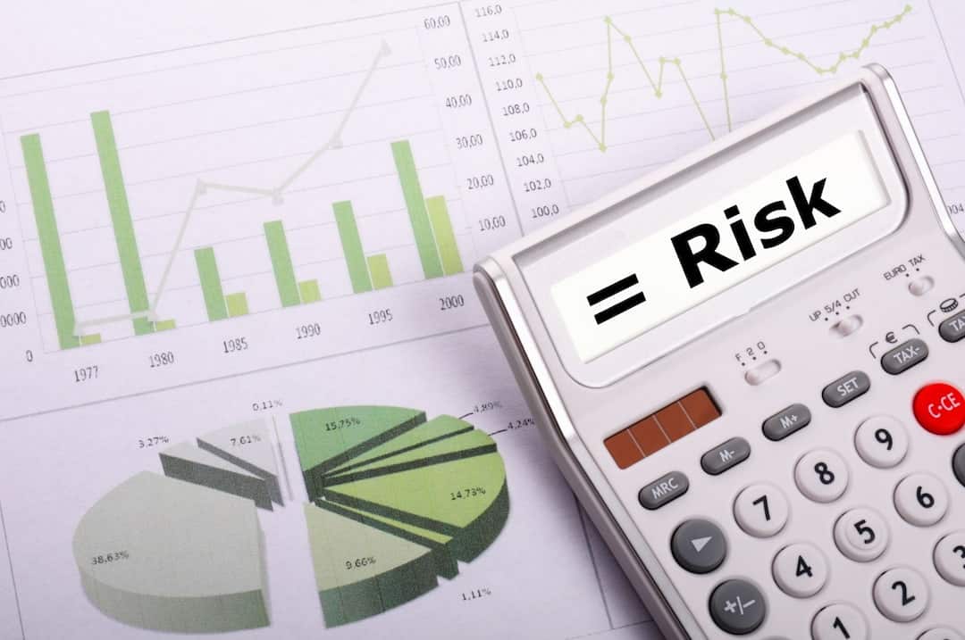 charts and calculator with the word RISK displayed