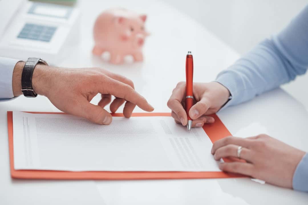 a woman signing the contract at the bank