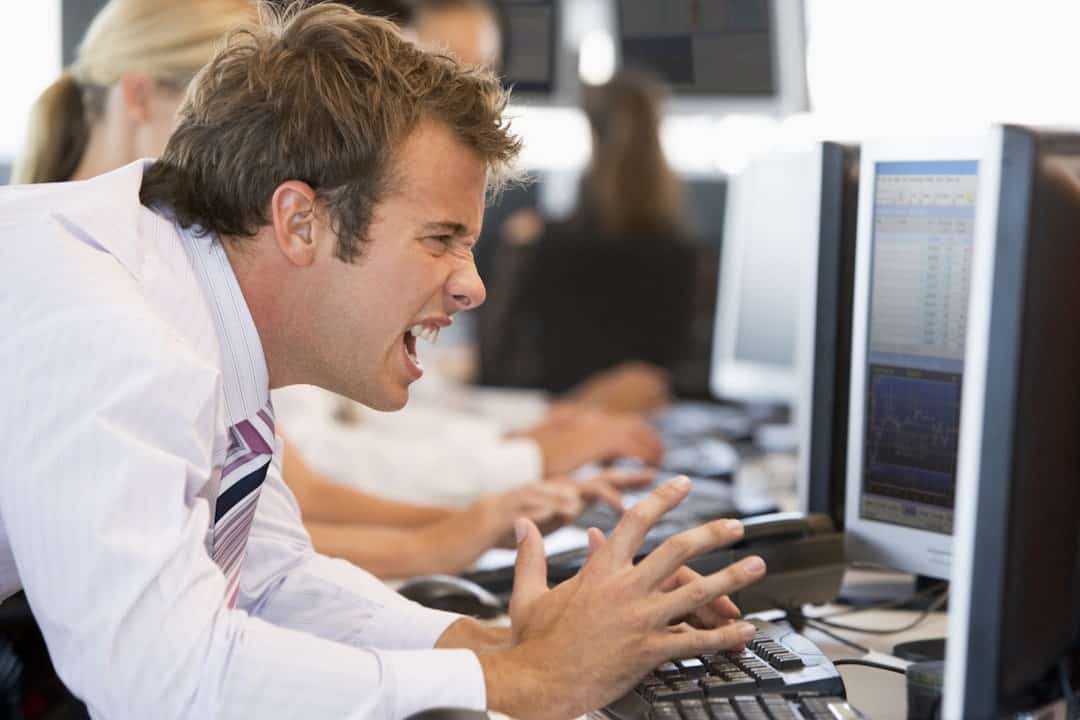 a man showing reaction while watching the screen